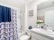 Bathroom featuring shower and tub combo, patterned shower curtain, and classic vanity at 7161 Sw 135Th Pl, Ocala, FL 34473