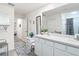 Bright bathroom featuring double sinks, decorative blue accents, and access to bedroom hallway at 7161 Sw 135Th Pl, Ocala, FL 34473