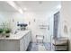 Bright bathroom featuring double sinks, decorative blue accents, and a convenient accessible shower chair at 7161 Sw 135Th Pl, Ocala, FL 34473