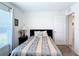 Bedroom with a dark wood headboard and light patterned bedding at 7161 Sw 135Th Pl, Ocala, FL 34473