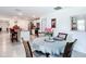 Bright dining room with table, chairs, and an open view of the kitchen at 7161 Sw 135Th Pl, Ocala, FL 34473