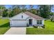 Charming single-Gathering home featuring a well-maintained lawn and attached two-car garage at 7161 Sw 135Th Pl, Ocala, FL 34473