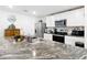 Spacious kitchen with a large island, granite countertops, and modern appliances at 7161 Sw 135Th Pl, Ocala, FL 34473