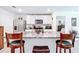 Open kitchen with granite countertops, stainless steel appliances, and barstool seating at 7161 Sw 135Th Pl, Ocala, FL 34473