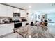 Bright kitchen featuring granite countertops, stainless steel appliances, and white cabinetry at 7161 Sw 135Th Pl, Ocala, FL 34473