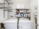 Laundry room with side by side washer and dryer, and wire rack shelving at 7161 Sw 135Th Pl, Ocala, FL 34473