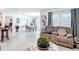 Open-concept living space with modern decor and seamless flow to the dining area at 7161 Sw 135Th Pl, Ocala, FL 34473