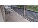 Screened in balcony featuring wood-like flooring and black metal railing at 844 Suffolk Pl, Davenport, FL 33896