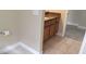Bathroom featuring tiled floors, a granite countertop, and dark cabinetry at 844 Suffolk Pl, Davenport, FL 33896