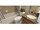 Bathroom featuring a tiled shower-tub combo and granite vanity at 844 Suffolk Pl, Davenport, FL 33896