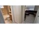 View of bathroom featuring a tiled shower-tub combo, granite vanity, and closet at 844 Suffolk Pl, Davenport, FL 33896