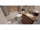 Well-maintained bathroom featuring a tiled shower-tub combo and granite vanity at 844 Suffolk Pl, Davenport, FL 33896