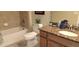 Bathroom with a granite-topped vanity, a tub-shower combo, and a neutral color palette at 844 Suffolk Pl, Davenport, FL 33896