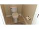Cozy bathroom featuring a standard toilet, neutral tile flooring, and a fresh, clean appearance at 844 Suffolk Pl, Davenport, FL 33896