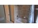 Well-maintained bathtub with tile surround and a shower curtain, next to a closet for added storage at 844 Suffolk Pl, Davenport, FL 33896
