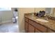Bathroom featuring tiled floors and a granite countertop with sink at 844 Suffolk Pl, Davenport, FL 33896