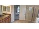 Bright bathroom featuring a granite vanity, a glass-enclosed shower, and tiled flooring at 844 Suffolk Pl, Davenport, FL 33896