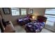 Charming bedroom featuring two twin beds with patriotic quilts, perfect for a guest room at 844 Suffolk Pl, Davenport, FL 33896