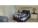Inviting bedroom features a comfortable bed with a stylish blue-and-white quilt and matching nightstands at 844 Suffolk Pl, Davenport, FL 33896