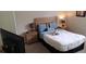 Comfortable bedroom with carpet, wooden furniture, and soft, inviting linens at 844 Suffolk Pl, Davenport, FL 33896