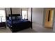 Bright bedroom showcasing a four-poster bed, bedside tables, and tile flooring in the hallway at 844 Suffolk Pl, Davenport, FL 33896