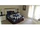 Cozy bedroom featuring a comfortable bed with stylish linens and two bedside tables with lamps at 844 Suffolk Pl, Davenport, FL 33896