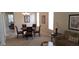Open dining area with a round table, six chairs, and modern decor, illuminated by a chandelier at 844 Suffolk Pl, Davenport, FL 33896