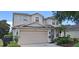 Charming two-story home with a well-manicured lawn, attached garage, and neutral exterior paint at 844 Suffolk Pl, Davenport, FL 33896
