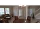 Spacious foyer featuring tile flooring, decorative columns, stairs, and a glass-paneled front door at 844 Suffolk Pl, Davenport, FL 33896