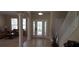 Elegant foyer with tile floors, decorative columns, a glass front door, and an adjacent living area at 844 Suffolk Pl, Davenport, FL 33896
