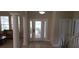 Bright foyer with decorative glass front door, tile flooring, and grand architectural columns at 844 Suffolk Pl, Davenport, FL 33896
