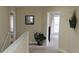 Upstairs hallway featuring a view of a bedroom and an outdoor balcony at 844 Suffolk Pl, Davenport, FL 33896