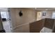 Well-lit hallway with neutral carpeting, leading to a bedroom and laundry room for convenience at 844 Suffolk Pl, Davenport, FL 33896