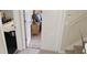 Hallway view showing entryway into a bedroom with nightstand and a game room with an air hockey table at 844 Suffolk Pl, Davenport, FL 33896