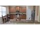 A kitchen featuring wooden cabinets, granite countertops, stainless steel appliances, and a kitchen island at 844 Suffolk Pl, Davenport, FL 33896