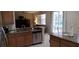 Open concept kitchen featuring granite countertops, stainless steel appliances, and seamless flow to living area at 844 Suffolk Pl, Davenport, FL 33896
