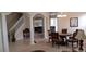 Open-concept living area with decorative columns, a staircase, a dining table, and a view into the kitchen at 844 Suffolk Pl, Davenport, FL 33896