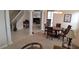 Bright, open living area with dining table, columns, and a view of the staircase and kitchen at 844 Suffolk Pl, Davenport, FL 33896