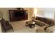 Inviting living room featuring a comfortable sofa, entertainment center, and natural light from the window at 844 Suffolk Pl, Davenport, FL 33896