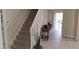 Carpeted staircase leading to the upper level of the home with lots of light at 844 Suffolk Pl, Davenport, FL 33896
