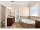 Bathroom featuring a bathtub, vanity with sink, and tile work at 922 Jasmine St, Celebration, FL 34747
