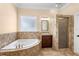 Bathroom features a soaking tub, vanity with a sink, and tiled shower at 922 Jasmine St, Celebration, FL 34747