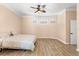 Bright bedroom with a light colored bed, hardwood floors, and natural light streaming through the windows at 922 Jasmine St, Celebration, FL 34747