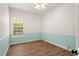 Bedroom with wood floors, a large window, and two-tone walls at 922 Jasmine St, Celebration, FL 34747