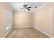 Neutral bedroom with tile floors, ceiling fan, and a view of the window at 922 Jasmine St, Celebration, FL 34747