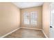 Bedroom with window letting in sunlight, light colored walls, and hardwood floors at 922 Jasmine St, Celebration, FL 34747