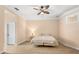 Spacious bedroom featuring a ceiling fan, a comfortable bed, and warm, neutral tones at 922 Jasmine St, Celebration, FL 34747