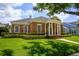 Beautifully landscaped home featuring a brick facade and elegant columned entrance at 922 Jasmine St, Celebration, FL 34747