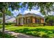 Elegant brick home with classic columns, manicured hedges, and a lush green lawn at 922 Jasmine St, Celebration, FL 34747