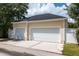 Detached two car garage with a white privacy fence and additional gated access at 922 Jasmine St, Celebration, FL 34747